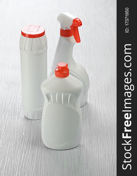 Three plastic bottles on the abstract gray background