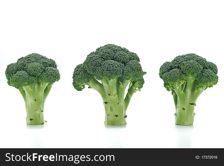 Three broccolis on a white background