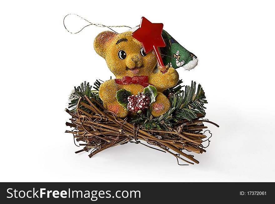 Christmas Toy as a teddy bear that sits on a pile of sticks with a red star with a light shade on white background. Christmas Toy as a teddy bear that sits on a pile of sticks with a red star with a light shade on white background