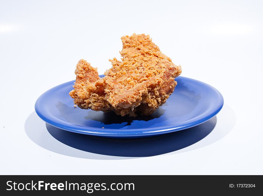 Fried chicken dish dark blue. Placed on a white background, then shoot.