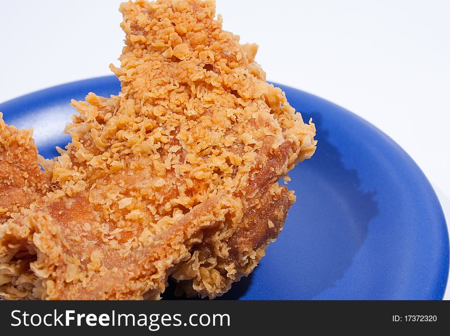 Fried chicken dish dark blue. Placed on a white background, then shoot.