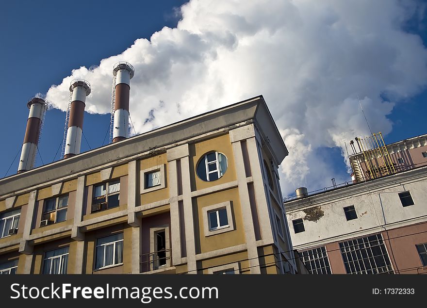 Pipe plant emit harmful substances. Against the blue sky. Industrial landscape.