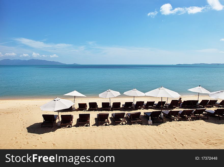 Beautiful tropical beach with white sunshades