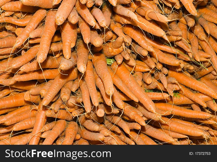 A bunch of yellow carrots in a vegetable market