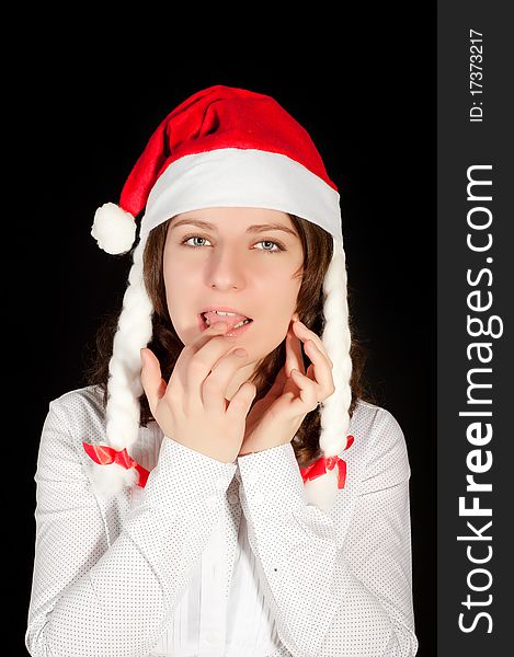 Beautiful young woman in red wearing santa hat. Isolated on white background.
