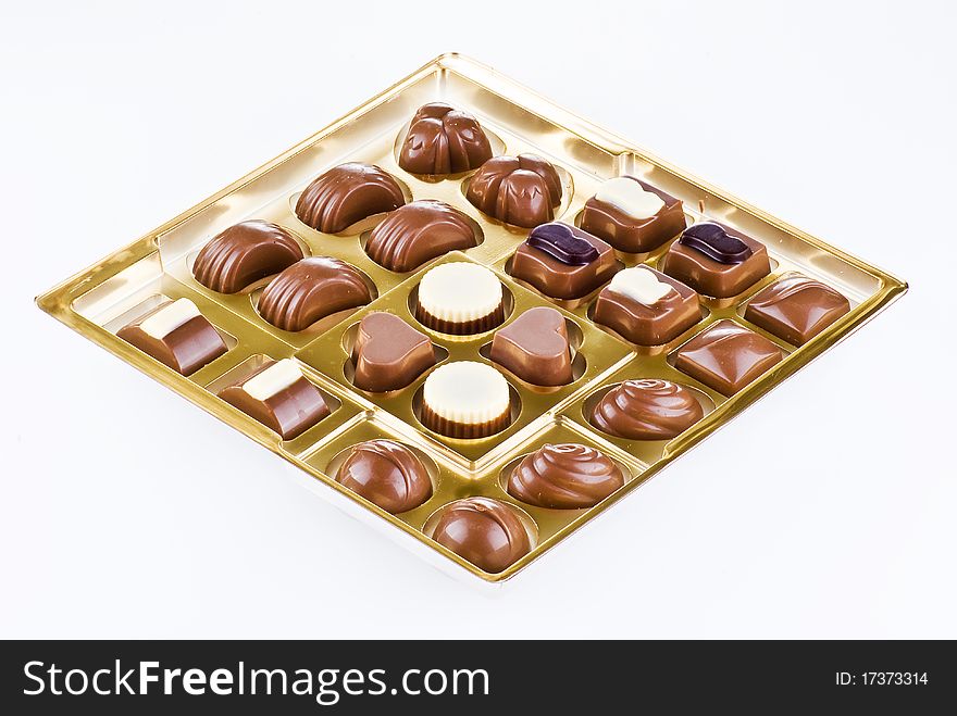 Assorted chocolates in the gold tray. Assorted chocolates in the gold tray