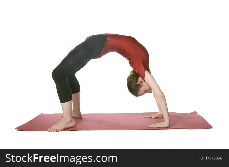 Woman doing a crab posture on a mat over white background. Woman doing a crab posture on a mat over white background