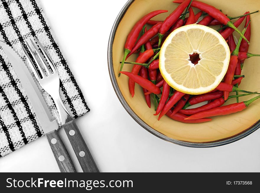 Composition of lemon, chilli, napkin and cutlery in black and white and colour version. Composition of lemon, chilli, napkin and cutlery in black and white and colour version