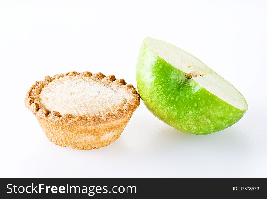 Freshly made apple pie and half of apple over white background