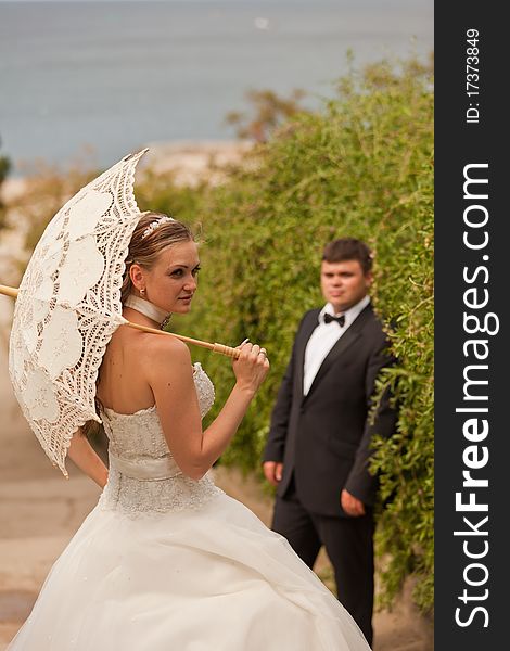 The bride and groom on the beach.