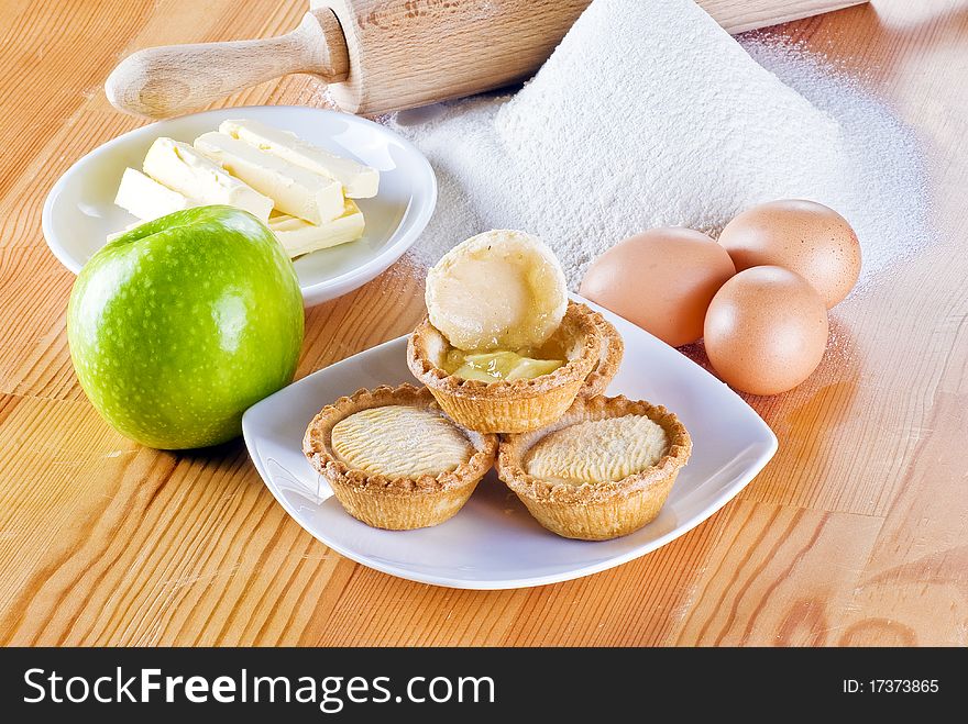 Freshly made apple pies on the table with one open. Freshly made apple pies on the table with one open