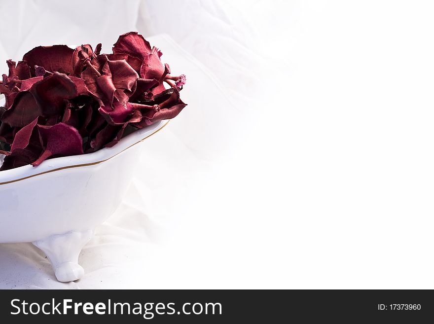 Christmas  red, white and purple potpourri flowers on white bath and white background. Christmas  red, white and purple potpourri flowers on white bath and white background