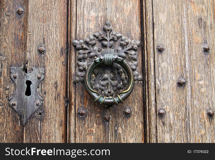 Antique Door Knocker On Wooden Door