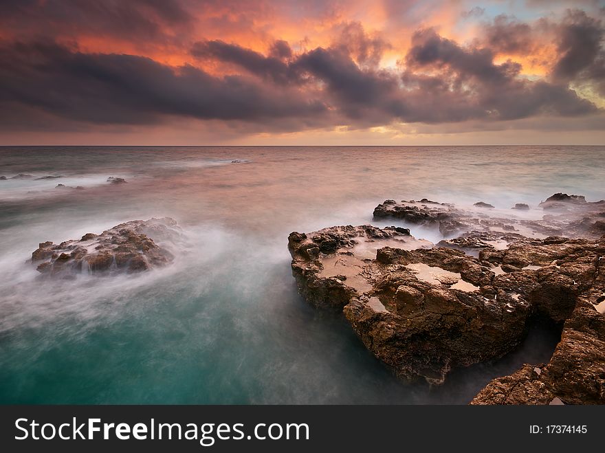 Beautiful seascape. Sea and rock at the sunset. Nature composition.