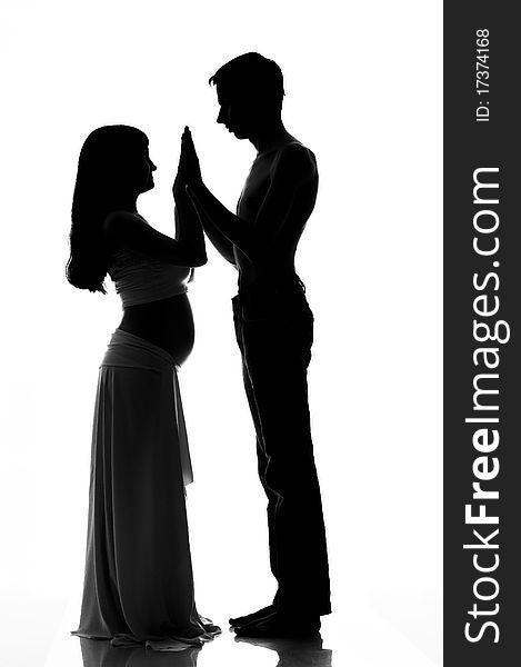 Pregnant couple silhouette on white