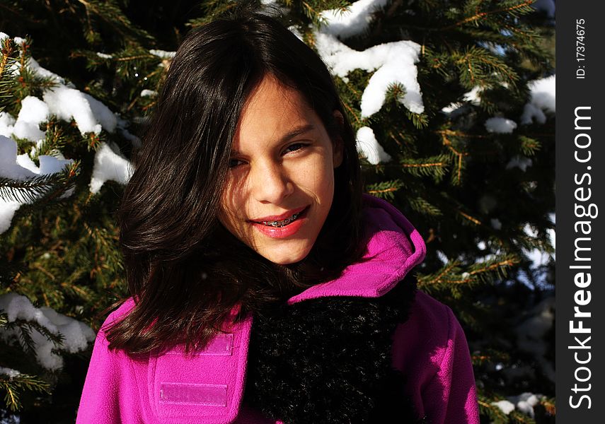 A young female hiker walking through a winter forest