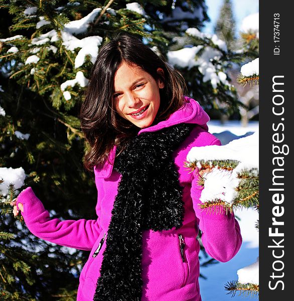 A young female hiker walking through a winter forest