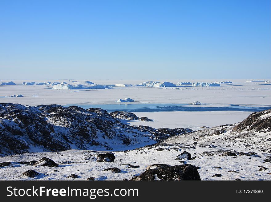 Frozen Sea and Icebergs off the coast of West Greenland