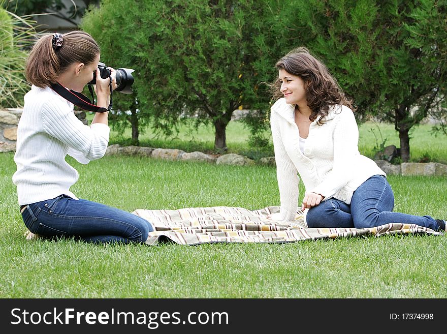 Young Women Taking Pictures On Natural Background