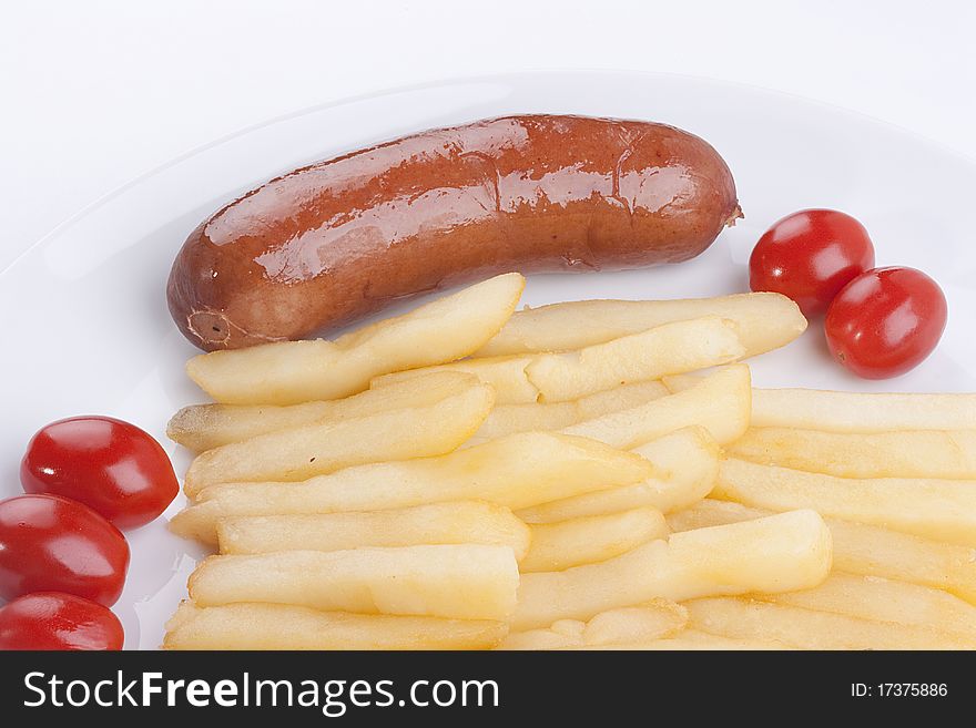 Fried potato with tomatoes and sausage on a plate.