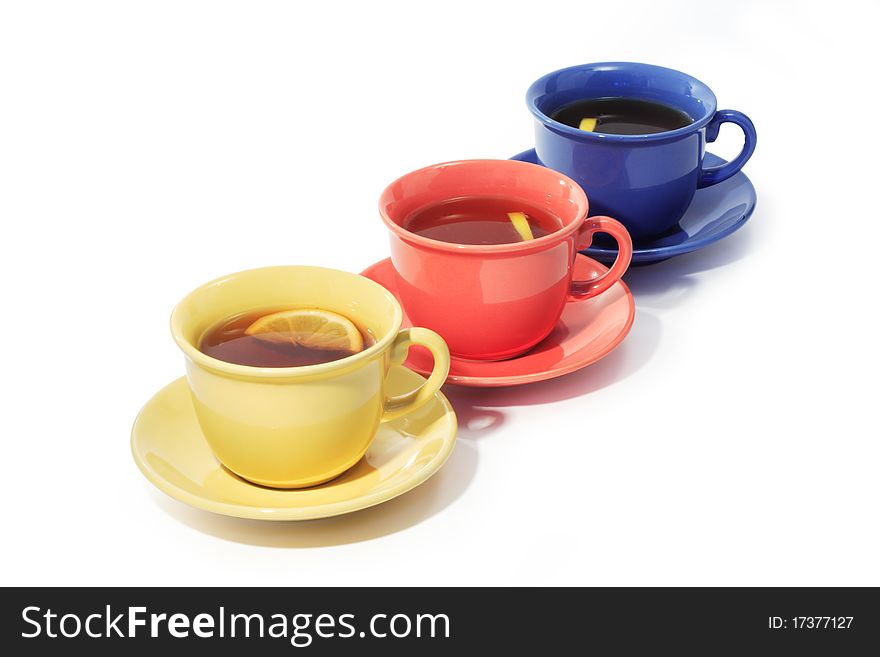 Three color cups of black tea with lemon isolated on white background with clipping path. Three color cups of black tea with lemon isolated on white background with clipping path