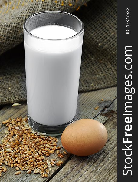 Milk, egg and wheat grain against sacking. Milk, egg and wheat grain against sacking