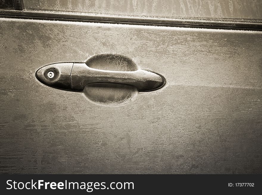 Sepia toned frosted vehicle door lever closeup