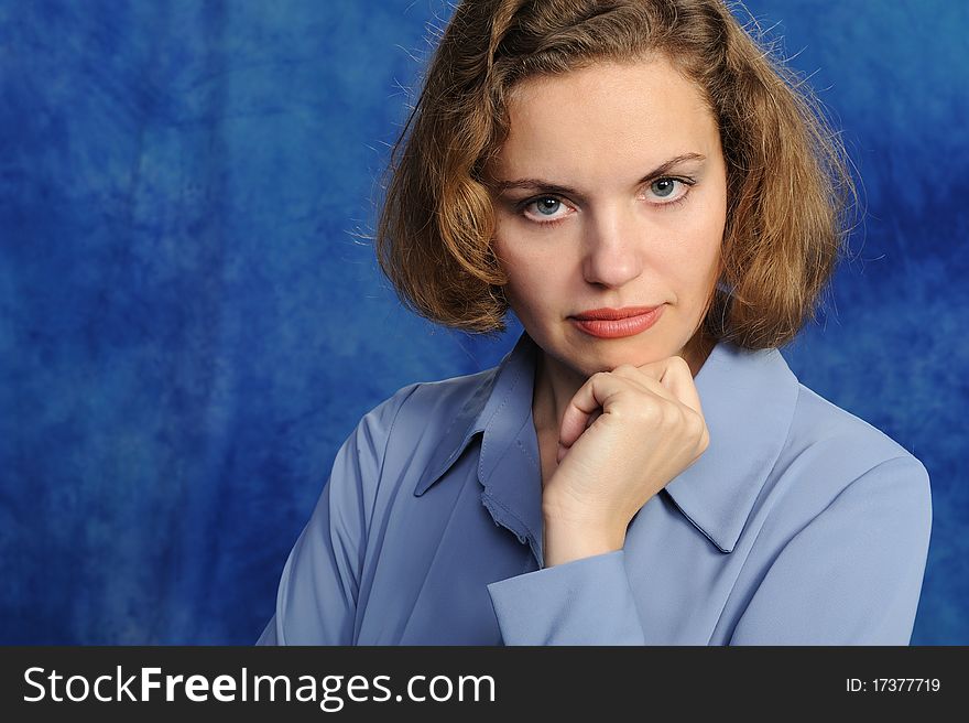 Portrait of the attractive woman on a blue background