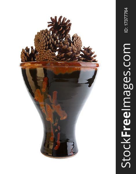 Brown ceramic vase with pine cones isolated on white