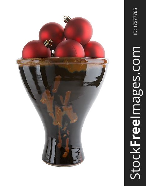 Brown ceramic vase with red christmas balls isolated on white