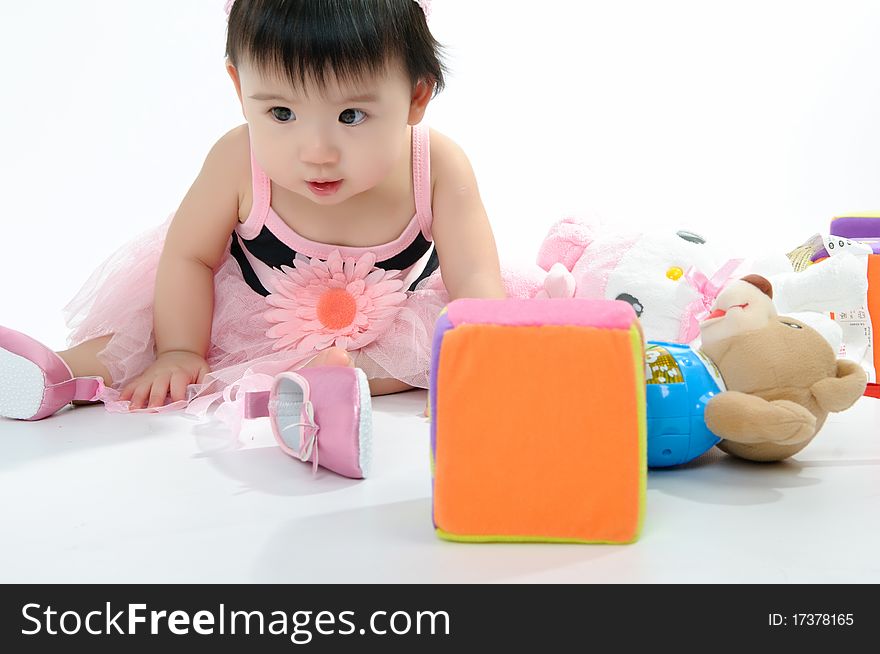 Kid in pink dress playing toy