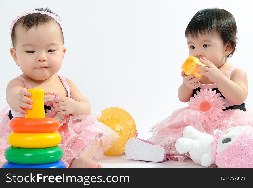 Kid in pink dress playing toy