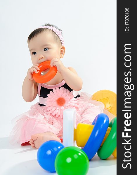 Kid In Pink Dress Playing Toy
