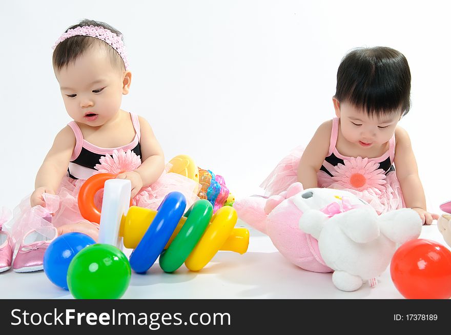 Kid in pink dress playing toy