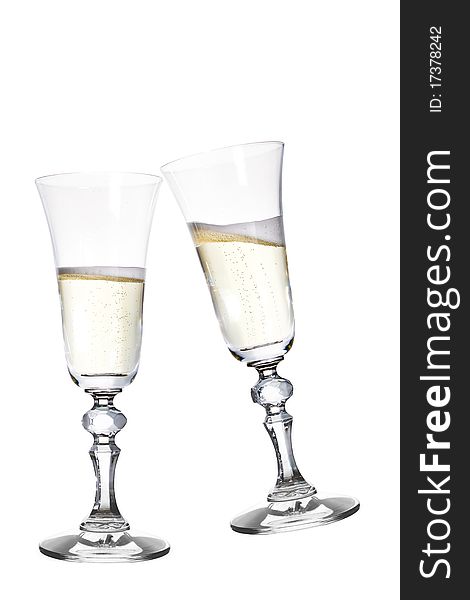 Pair of champagne flutes making a toast. Isolated on white. Pair of champagne flutes making a toast. Isolated on white