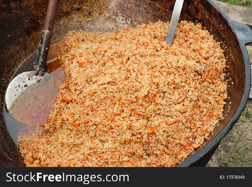 Boiled rice with carrots, an onion, peas, a barberry, a saffron, and various meat: mutton, beef, a chicken - a popular dish in the Asian countries. This picture is made on Turkish rural wedding. Boiled rice with carrots, an onion, peas, a barberry, a saffron, and various meat: mutton, beef, a chicken - a popular dish in the Asian countries. This picture is made on Turkish rural wedding.