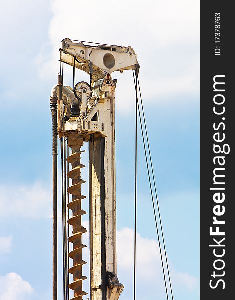 Auger detail part over blue sky with clouds. Auger detail part over blue sky with clouds