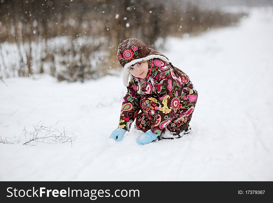 Small girl in strong snow fall