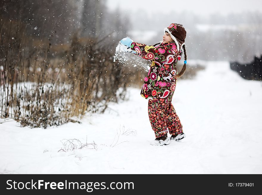 Small girl in strong snow fall