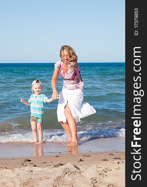 Mother And Son  On The Beach.