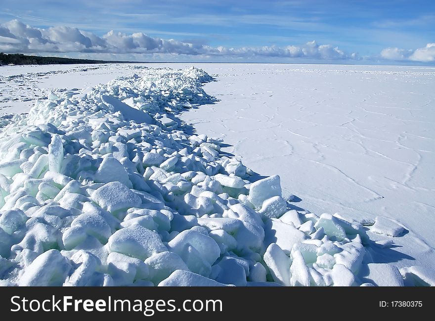 Landscape with the frozen gulf and ice floes