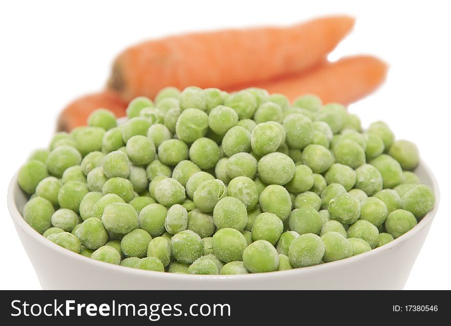 Frozen peas and carrots isolated on white. Frozen peas and carrots isolated on white