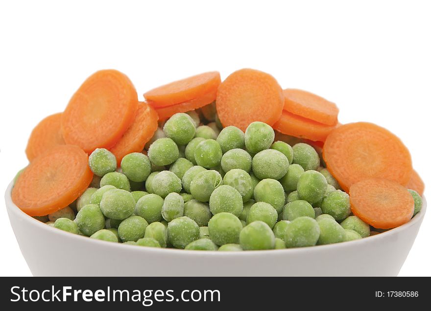 Carrots and green peas isolated on white