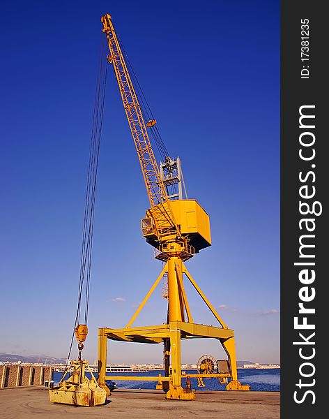 Yellow dock crane used to load cargo ships