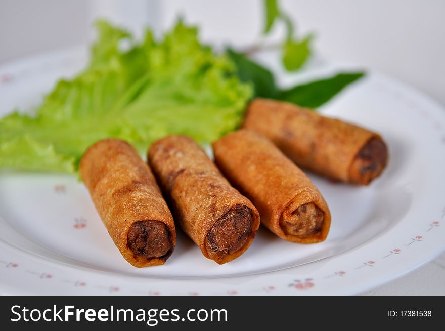 Fried spring rolls served with vegetables.