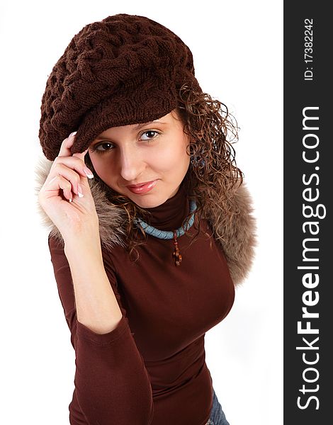 Portrait of the beautiful young girl in a winter cap and with a scarf isolated on a white background. Portrait of the beautiful young girl in a winter cap and with a scarf isolated on a white background