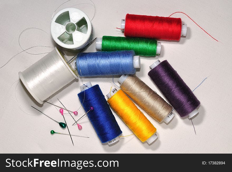 Spools of color threads and safety pins