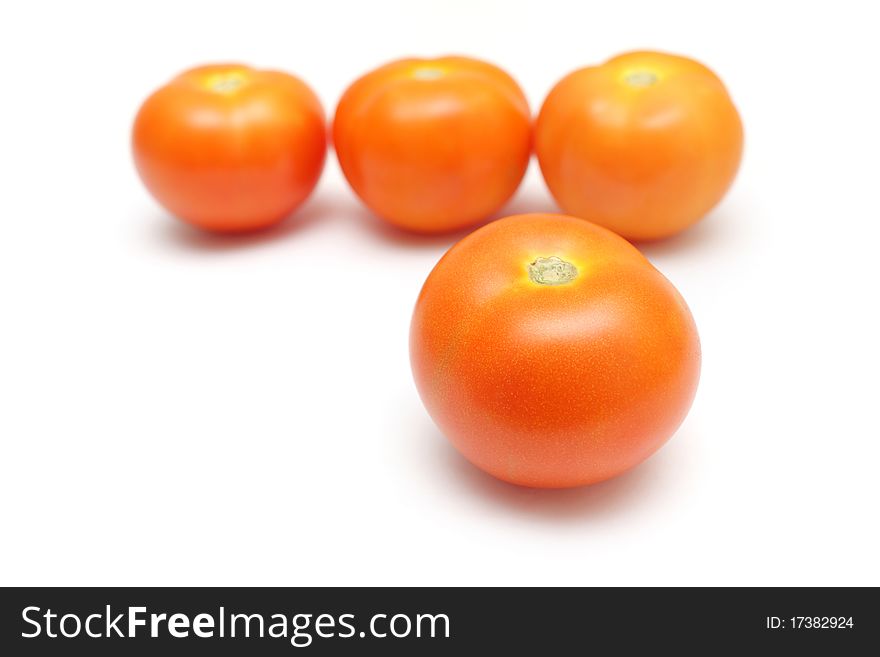 Close up of four tomatoes isolated on white background.