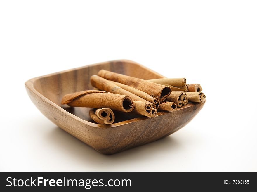 Cinnamon poles in the wood bowl. Cinnamon poles in the wood bowl