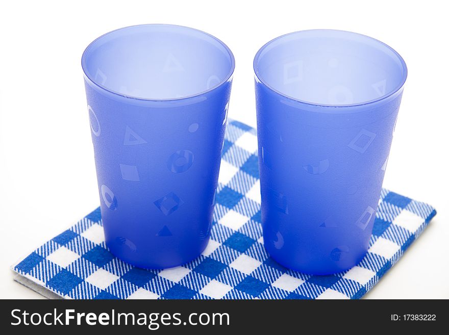 Blue cups on blue white table cloth